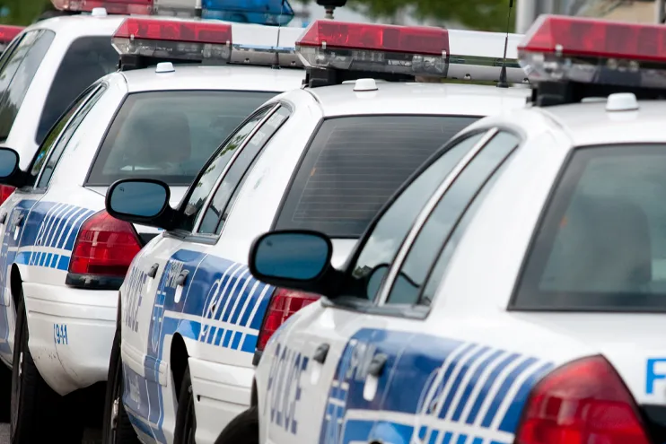 Fleet of police cars in a lot lined up 2