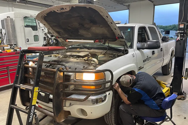 Mechanic at Dynamic Fleet Services working a Mint City Utility Services truck