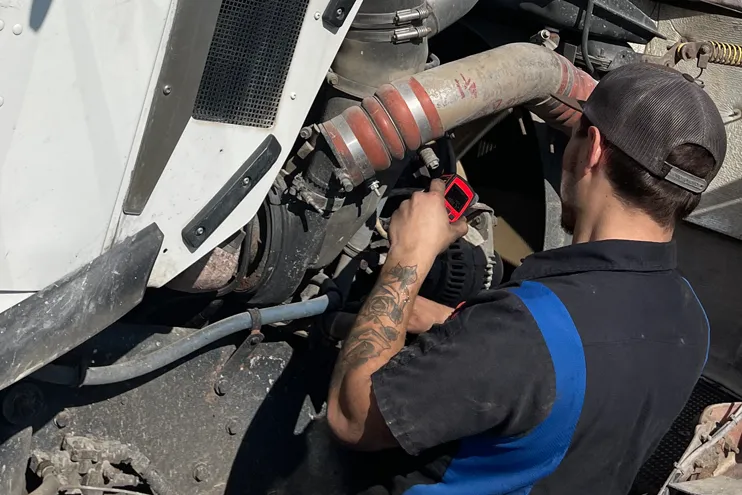 Mechanic at Dynamic Fleet Services working on a truck repair in the yard Mechanic at Dynamic Fleet Services working on a truck repair in the yard