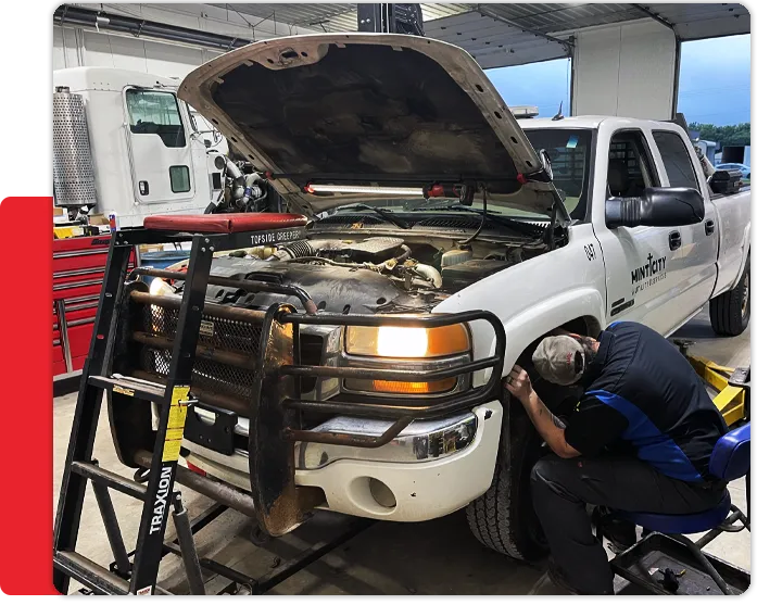 Mechanic at Dynamic Fleet Servicesd fixing a utility truck in Bremen IN Fleet vehicle mechanic fixing a utility truck in Bremen IN