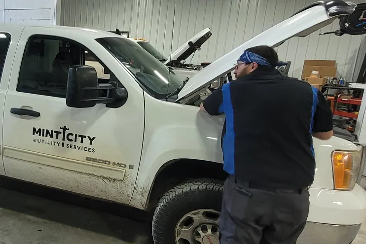 mint city utility services company truck being looked at by a mechanic at Dynamic Fleet Services mechanic