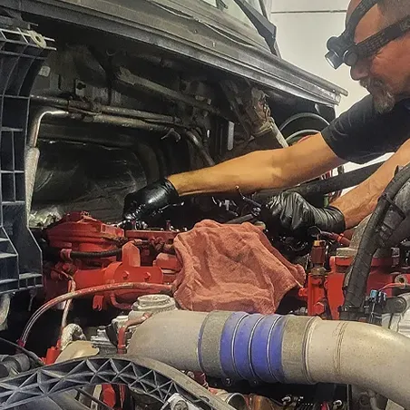 shot of Dynamic Fleet Services mechanic fixing a vehicle shot of Dynamic Fleet Services mechanic fixing a vehicle